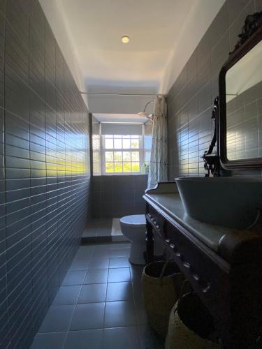 a bathroom with a sink and a toilet at Casa 3 Picos 1 in São Roque do Pico