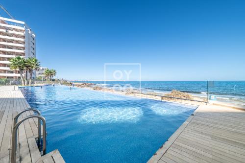 Infinity Blue groundfloor apt, beachfront, heated pool - by OYOOSTAYS