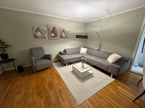 a living room with a couch and a table at Apartment with a beautiful view in the center of Ålesund in Ålesund
