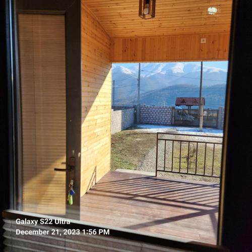 a door to a balcony with a view of the mountains at Comfort Chalet in Dilijan
