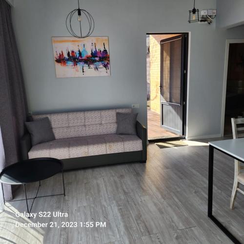 a living room with a couch and a table at Comfort Chalet in Dilijan