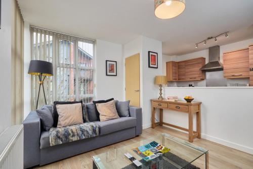 a living room with a couch and a table at Wilford View in Nottingham