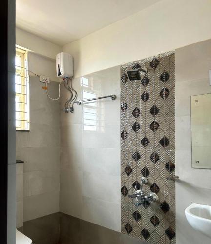 a bathroom with a shower and a sink at Hotel Crystal INN in Bhubaneshwar