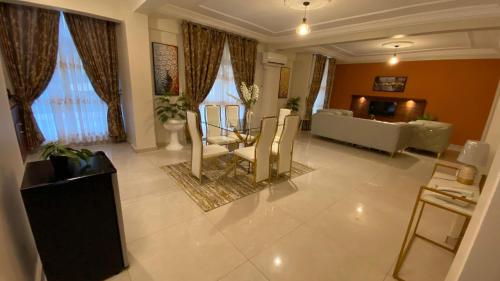a living room with a couch and a table at Résidence hôtelière MEDOM Palace, Bastos in Yaoundé