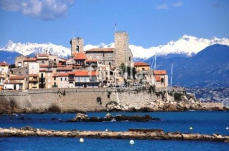 a town on an island in the water with mountains at Antibes Old Town Haven in Antibes