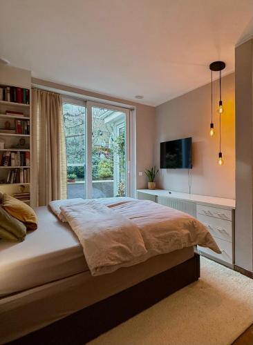 a bedroom with a large bed and a window at Briller Palais in Wuppertal