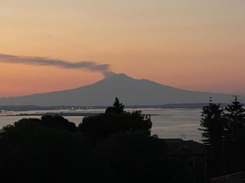 a view of a mountain at sunset with a body of water at A Ficu Pala in Siracusa