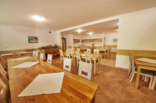 a dining room with wooden tables and chairs at Rute Hotel and Apartments in Kranjska Gora