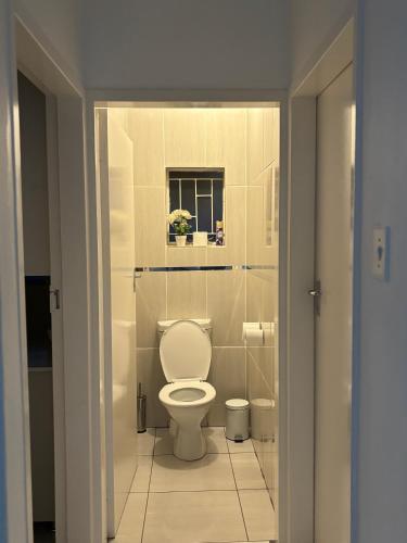 a bathroom with a toilet and a window at Blissful stay in Polokwane