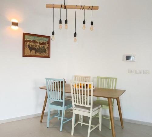 a dining room with a table and four chairs at Your Perfect Place by the Mediterranean in H̱adera