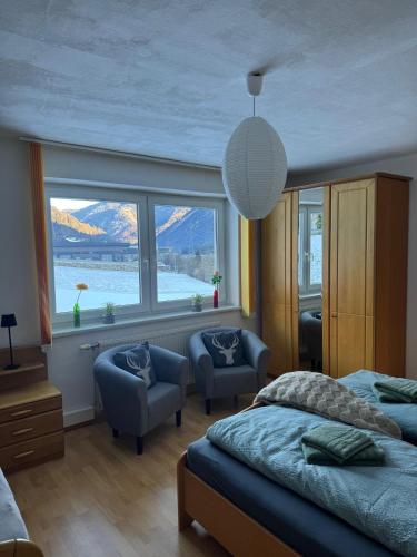 a bedroom with two beds and a large window at Ferienwohnung Die Möll in Latzendorf