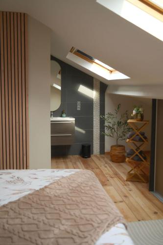 a bedroom with a bed and a mirror and a sink at La mezzanine 159 in Namur