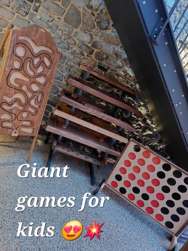 a game table and a chair next to a fireplace at La Renaissance 1&2 high standing guest house in Herve