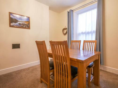 a dining room with a wooden table and chairs at The Black Boy Inn in Caernarfon