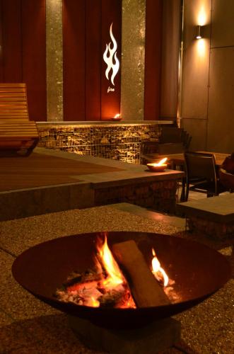 a fire pit in a building with flames in it at La Renaissance 1&2 high standing guest house in Herve