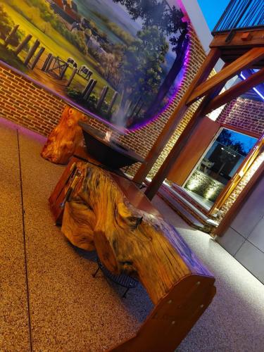 a wooden bench sitting in front of a building at La Renaissance 1&2 high standing guest house in Herve