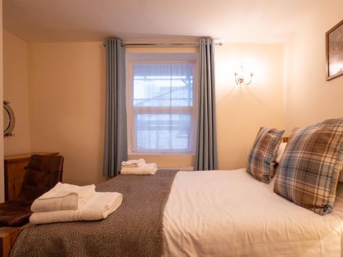 a bedroom with a bed and a window at The Black Boy Inn in Caernarfon