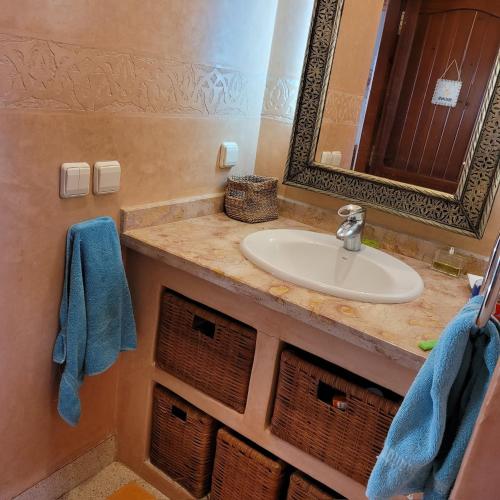 a bathroom with a sink and a mirror at Villa du soleil in Mirleft