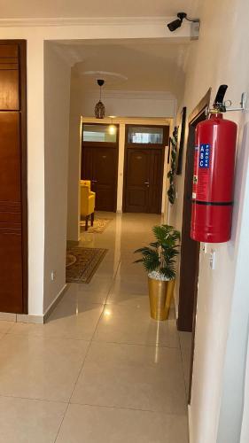 a living room with a red fire hydrant on the wall at Résidence hôtelière MEDOM Palace, Bastos in Yaoundé