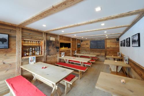 a dining room with wooden tables and benches at Alpinhotel Bort in Grindelwald