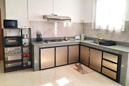 a kitchen with a sink and a counter top at Beach Pearl in Flic-en-Flac