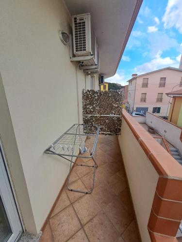 a chair sitting on the balcony of a building at B&B Metalla in Iglesias