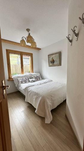 a bedroom with a large bed and a window at Chalet apartment & mountain view in Saas