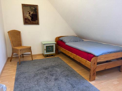 a small bedroom with a bed and a chair at Cleverland Appartement in Hannover