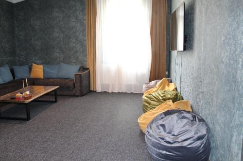 a living room with a couch and a table at Hotel Eden in Mestia