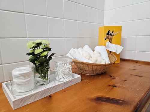 a table with a basket of towels and a vase of flowers at Chalet Alpin vue Dent Blanche in La Forclaz