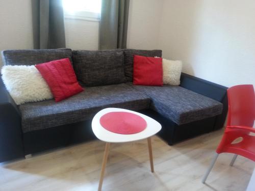 a living room with a couch with colorful pillows at Domki w Zacisznej Zagrodzie in Jerzykowice