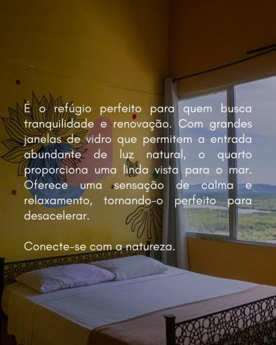 a bedroom with a bed with a sign on the wall at Banana Leaf Eco Hostel in Barra de Guaratiba