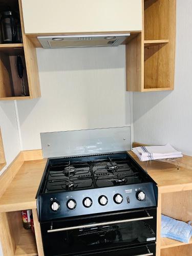 a stove top oven sitting in a kitchen at KEE Holiday Home Caravan in Great Yarmouth