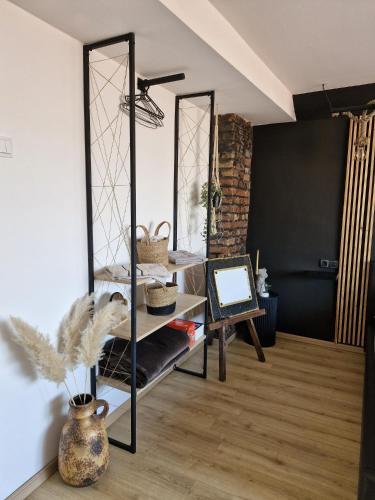 a living room with a mirror and a table at Gondola Apartment in Sarajevo