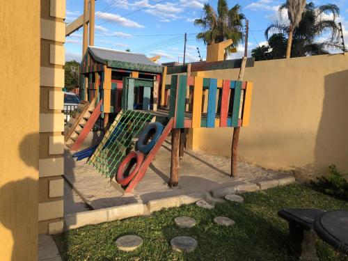 a playground with colorful playground equipment next to a building at Serviced 2 Bedroom in Long Acres in Lusaka