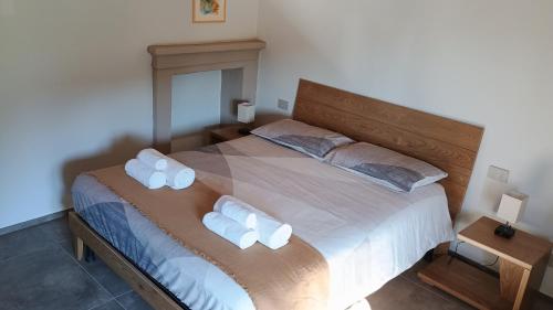 a bedroom with a large bed with two pillows at Dimora Belebun in Monforte dʼAlba