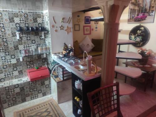 a doll house kitchen with a counter and a table at Port France in Tunis