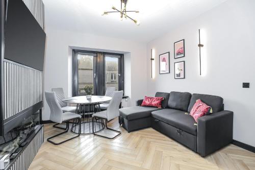 a living room with a couch and a table at 1 Bedroom Gorgie Sleeps 4 Easy City Access in Edinburgh