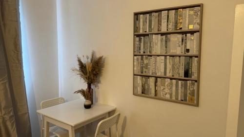 a room with a table and a shelf with books at Big Confort, Shared House in Bristol