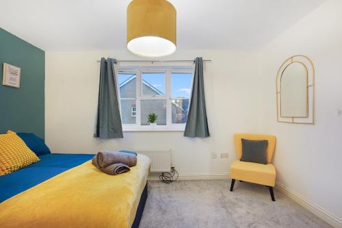 a bedroom with a bed and a chair and a window at Ashford Stay Parkfarm location Comfortable with Netflix to chill in Ashford