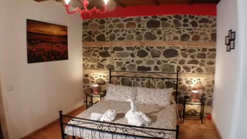 a bedroom with a bed with two swans on it at L’ANGOLETTO in San Lorenzo Nuovo