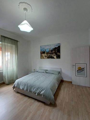 a bedroom with a bed in a white room at M&M Apartment in Ponte Lucano