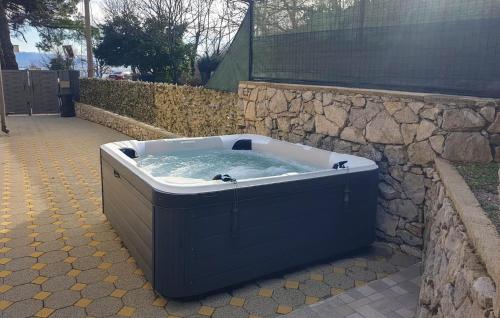 a large blue bath tub with water in it at 2 Bedroom Cozy Apartment In Rukavac in Rukavac