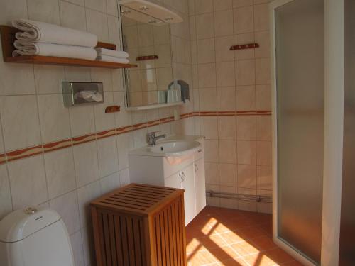 a small bathroom with a sink and a mirror at Tössestugan in Tösse
