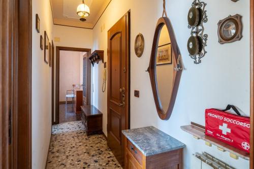a hallway with a mirror on the wall at Casa Nina Quadrilocale Top a 50m dal Mare in Pietra Ligure