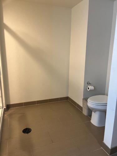 a bathroom with a toilet and a tile floor at Comfort Suites Denver International Airport in Denver