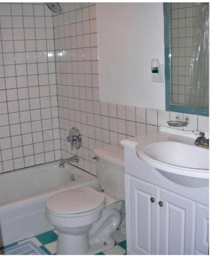 a bathroom with a toilet and a sink at Waterfront house in Falmouth