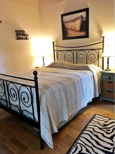 a bedroom with a bed and two lamps and a rug at Waterfront house in Falmouth
