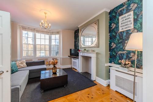 a living room with a couch and a table at Spacious Brighton Beach Town House I Stag Do & Hen Party Welcome in Brighton & Hove