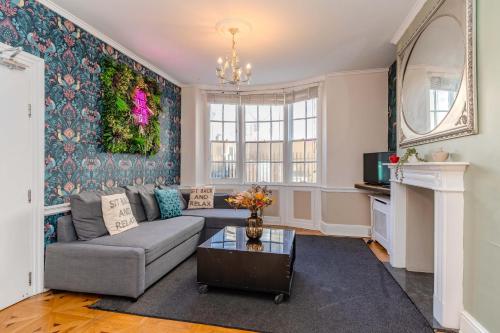 a living room with a couch and a table at Next to Brighton Beach I Super central Big House in Brighton & Hove